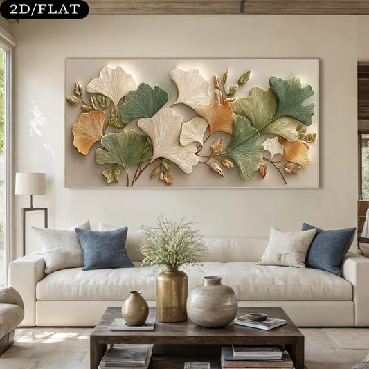 A large rectangular wall art piece featuring a 3D relief design of ginkgo leaves in shades of green, beige, and gold, displayed above a modern white sofa in a styled living room.