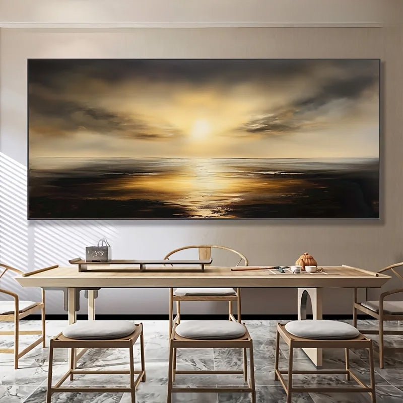 A large horizontal canvas wall art print depicting a golden sunset over calm water, displayed in a modern dining room setting above a wooden dining table and chairs.