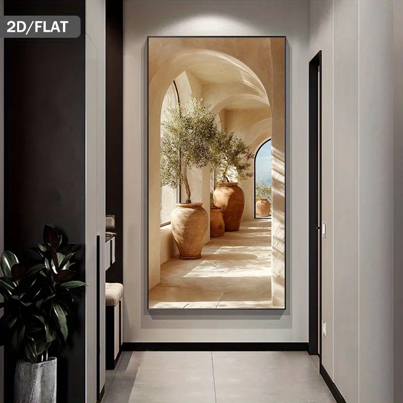 A tall framed wall art print showing a sunlit architectural corridor with arches, large terracotta pots, and olive trees, displayed in a modern hallway. A small label in the top-left reads “2D/FLAT.