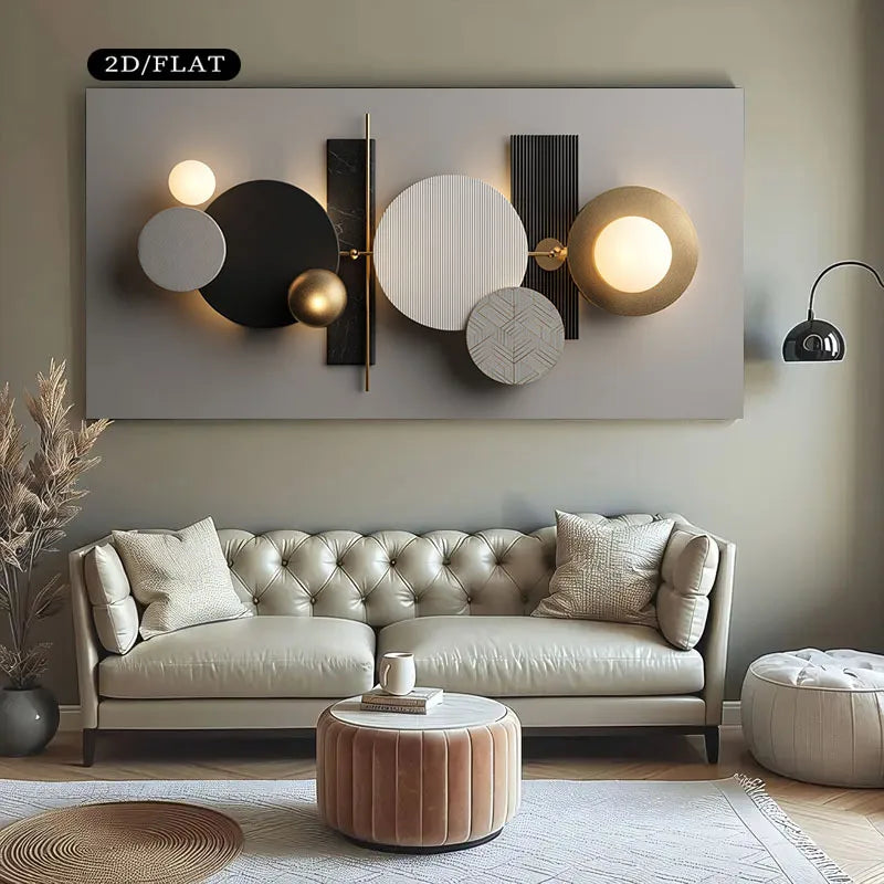 A modern abstract wall art piece with circular and rectangular geometric shapes in black, white, gray, and gold, mounted above a tufted sofa in a styled living room.