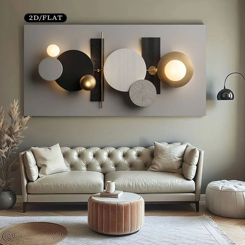 A modern abstract wall art piece with circular and rectangular geometric shapes in black, white, gray, and gold, mounted above a tufted sofa in a styled living room.