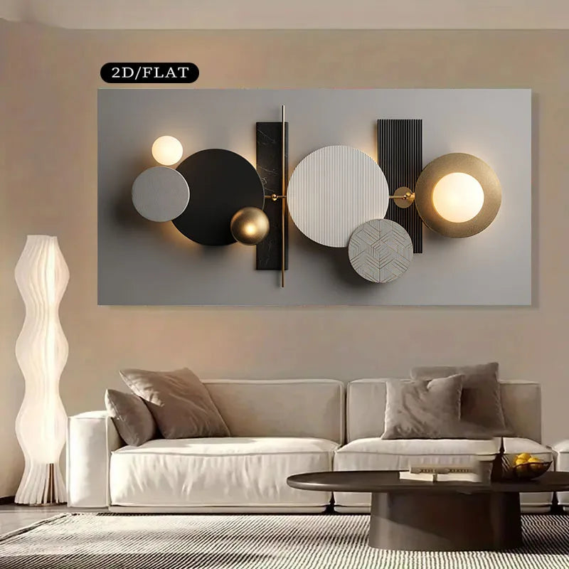 Modern abstract wall art featuring geometric circles, spheres, and rectangular forms in black, white, gray, and gold tones, displayed above a light beige sofa in a styled living room setting.