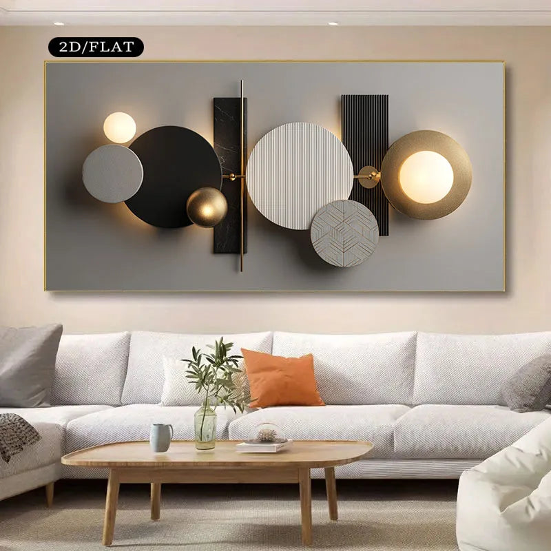 Modern abstract wall art with overlapping circles and rectangular forms in black, white, gray, and gold, shown mounted above a light sofa in a living room setting. A black label in the top left reads “2D/FLAT.