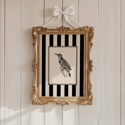 Decorative framed picture with a bird illustration on a striped background, hanging on a wooden wall.