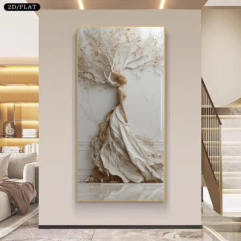 A large vertical wall art piece hangs on a beige wall in a modern interior. The artwork depicts a stylized white tree with flowing drapery-like branches and gold leaf accents, resembling a sculptural tree of life.