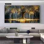 A large rectangular wall art print showing a glowing tree with golden light reflections, displayed above a modern sofa in a living room. 