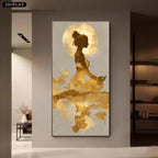 A vertical wall art print showing a meditating woman silhouette with a large gold moon and gold brushstroke details on a pale background, displayed in a modern interior hallway.