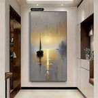 A 2D flat canvas wall art print depicting a serene sunset over a lake with a sailboat, displayed in a modern hallway setting.