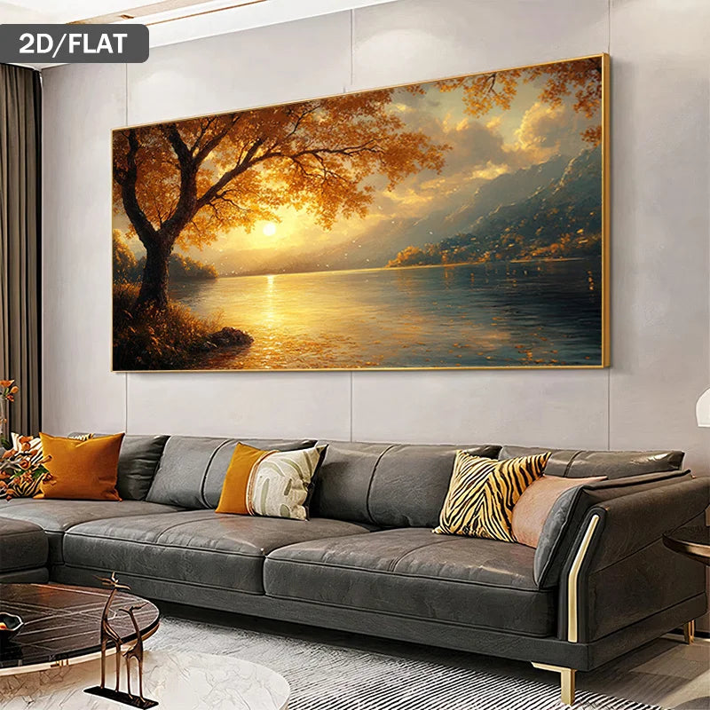 A large landscape painting of a golden sunset over a lake with mountains in the distance, displayed on a light gray wall above a modern gray sofa with decorative pillows in a living room setting.