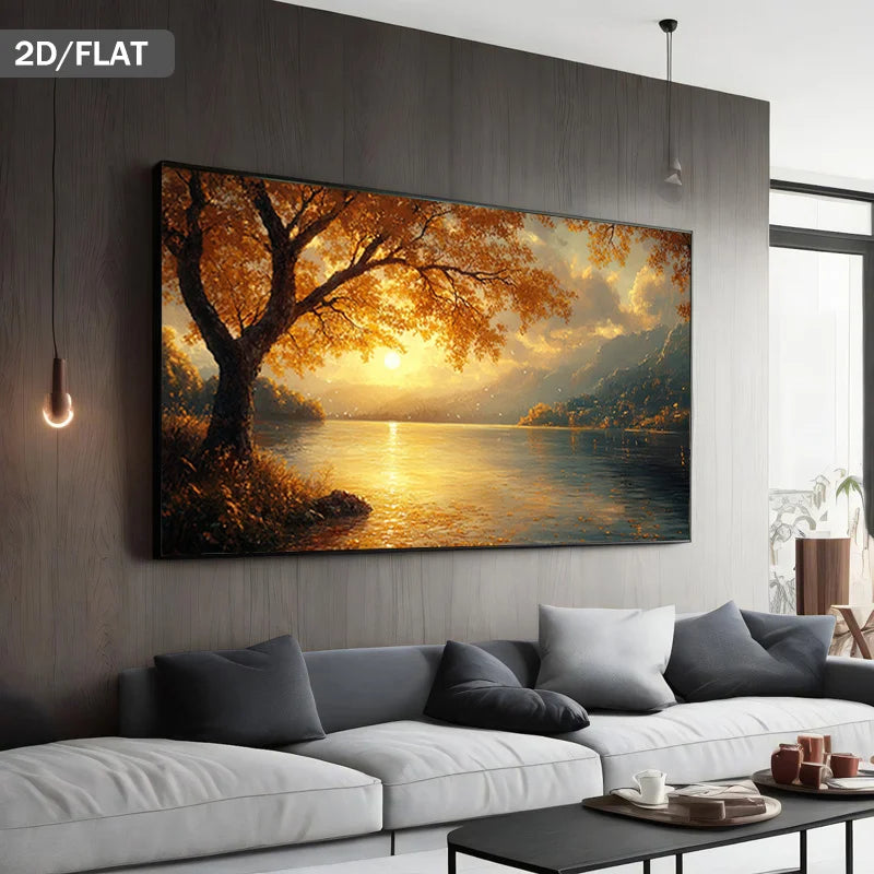 A large rectangular wall art print showing a golden autumn tree by a lake at sunset, displayed above a modern gray sofa in a styled living room. The image includes a '2D/FLAT' label in the top-left corner.
