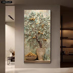 A vertical wall art piece showing a textured painting of a pomegranate tree with green leaves and golden pomegranates in a vase, displayed on a beige wall in a modern interior setting.