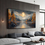 A large landscape wall art print hangs above a white sofa in a modern living room. The artwork depicts a moonlit mountain lake scene with golden autumn trees, dark rocks, and snowy peaks reflected in the water.