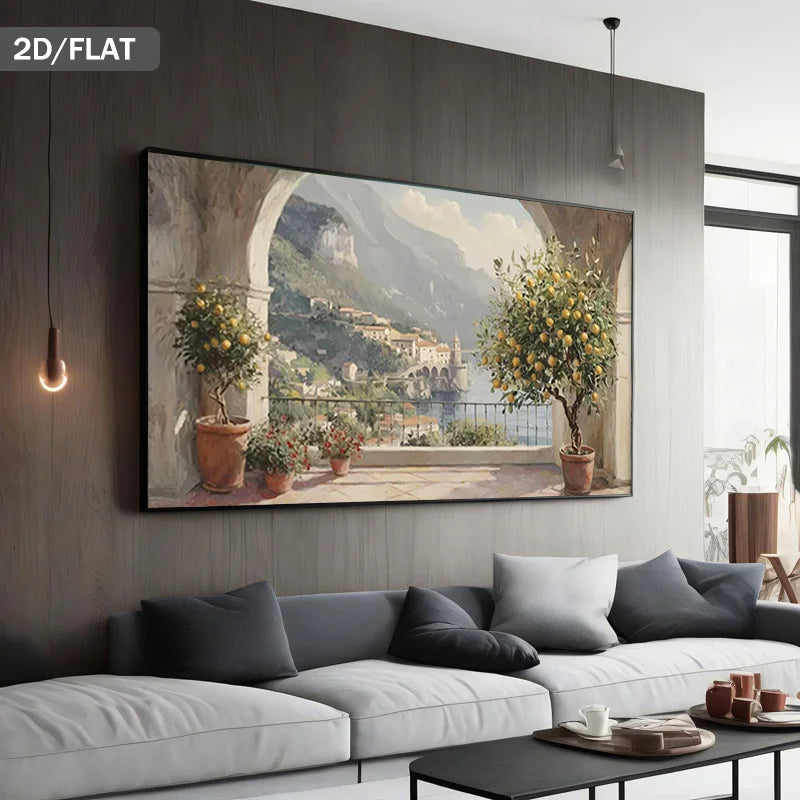 A large wall art print showing a scenic coastal village with lemon trees and mountains, displayed above a modern white sofa in a contemporary living room. The text '2D/FLAT' appears in the top-left corner.