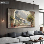 A large wall art print showing a scenic coastal village with lemon trees and mountains, displayed above a modern white sofa in a contemporary living room. The text '2D/FLAT' appears in the top-left corner.