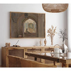 A framed art print depicting an arched architectural interior hangs on a white wall above a light wood credenza in a styled dining room setting.