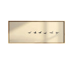 Decorative wall art with five birds in flight on a gold background