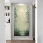 A vertical canvas wall art print depicting a misty bamboo forest with a glowing sun and birds, displayed on a light gray wall in a modern hallway with a bookshelf on the left.
