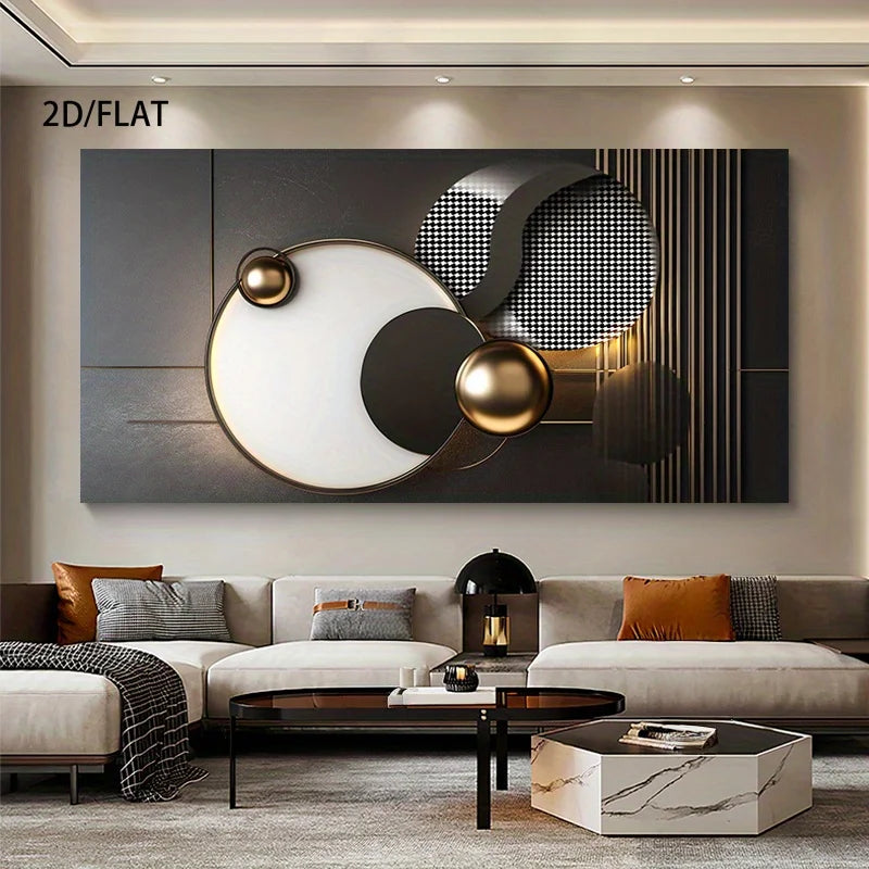 A large abstract wall art piece with geometric shapes in black, white, gray, and metallic gold, displayed above a modern beige sofa in a styled living room. 