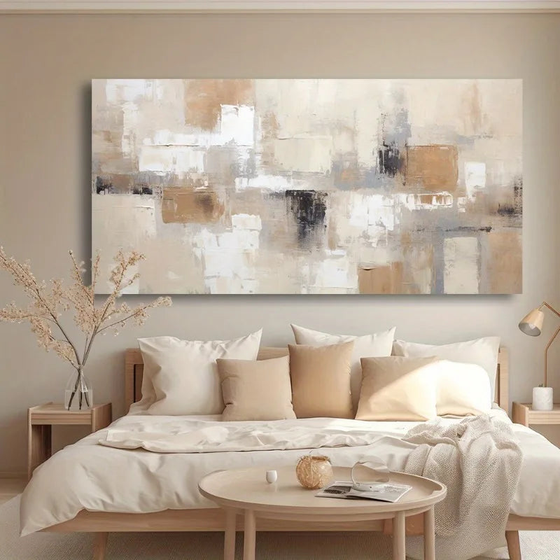 A large abstract canvas wall art print in beige, white, brown, and gray tones, displayed above a neatly made bed in a modern, minimalist bedroom setting.