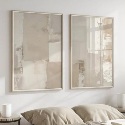 Two framed abstract paintings on a wall above a bed.