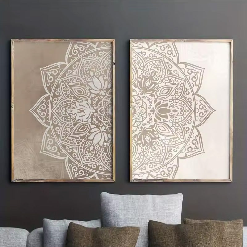 Two framed mandala art prints hanging side-by-side on a dark gray wall above a light gray sofa with brown pillows.