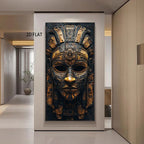 A large vertical wall art print showing an ornate gold and black ancient Aztec-style mask, displayed in a modern hallway with the text '2D FLAT' near the upper left.