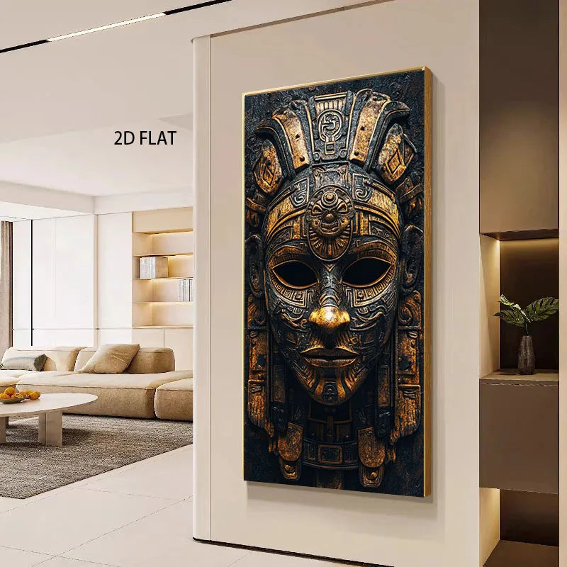 A large vertical wall art print showing an ornate gold and black ancient Aztec-style mask, displayed in a modern living room setting on a beige wall with the text '2D FLAT' visible nearby.