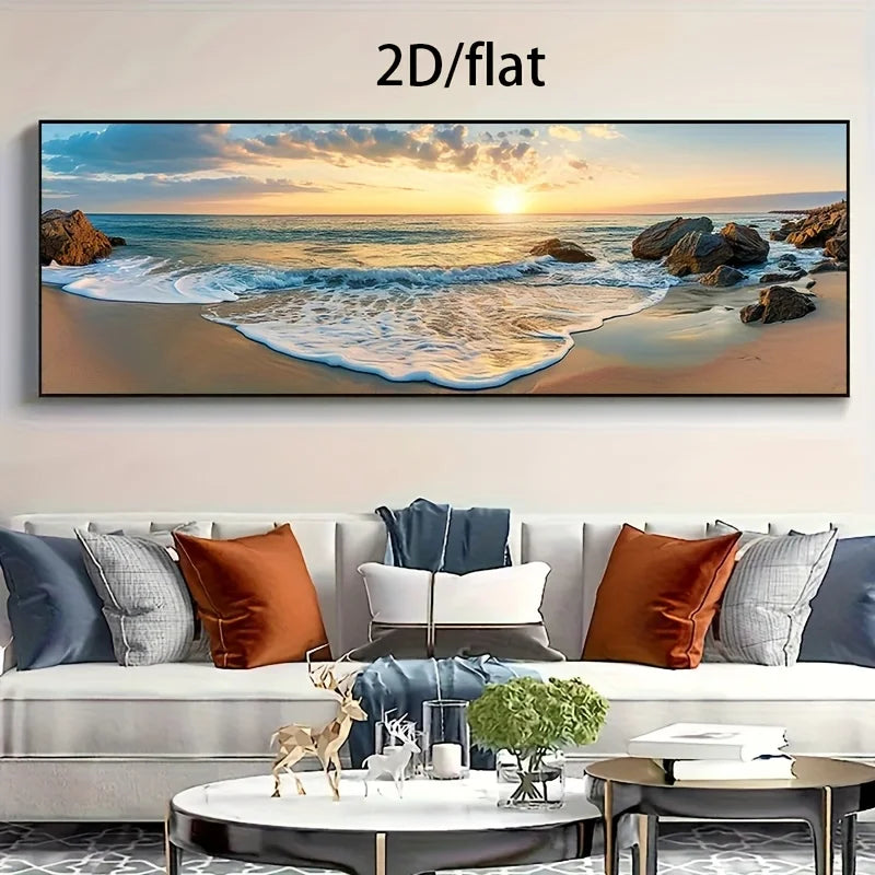 A large panoramic framed wall art print showing a beach sunset with ocean waves, rocks, and golden sky, displayed above a modern sofa in a living room. The text '2D/flat' appears at the top of the image.