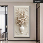 A large vertical framed wall art piece featuring a 3D-style cream floral arrangement in a white vase, mounted on a beige wall in a modern interior hallway. A small '2D/FLAT' label appears in the top-right corner.