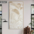 A vertical rectangular wall art panel with embossed tropical palm leaves and floral motifs in a warm cream tone, shown hanging on a light wall in a styled interior. A black lamp appears on the left and a plant and chair are partially visible on the right.